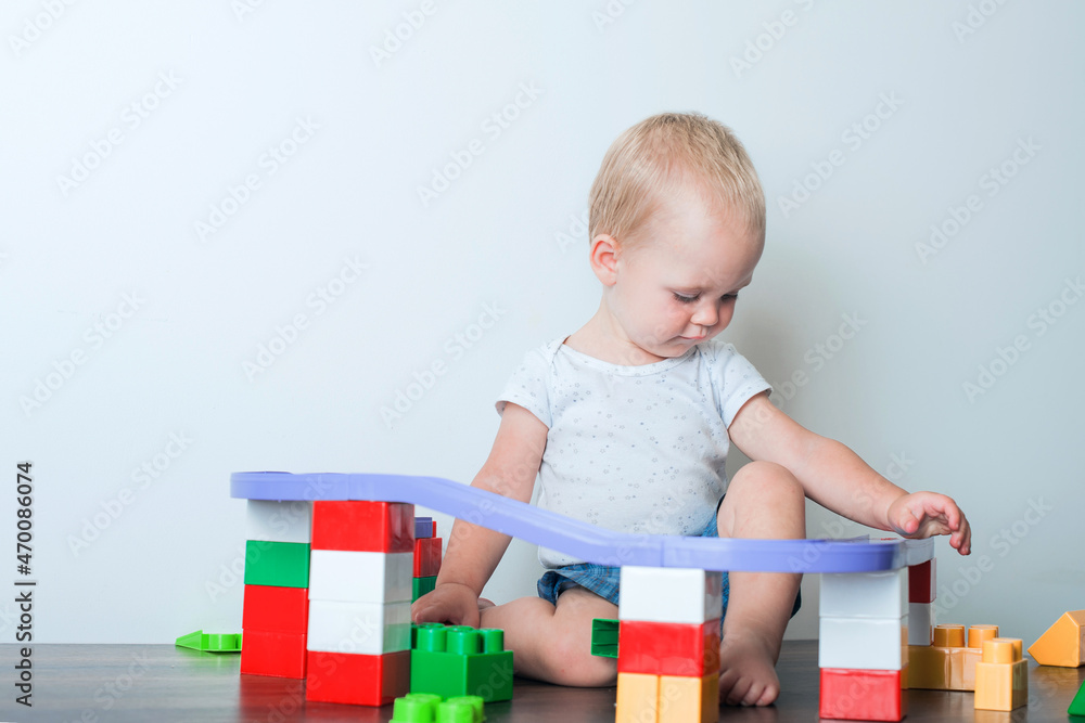Toddler boy plays with constructor, cars, blocks close-up. Educational toys for preschool children... Toddler boy plays with constructor, cars, blocks close-up. Educational toys for preschool children...