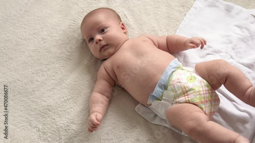 infancy, childhood, motherhood, hygiene, medicine health -mother changing baby diaper at home caring for happy newborn infant loving mom cleaning childs nappy moisturizing skin enjoying childcare