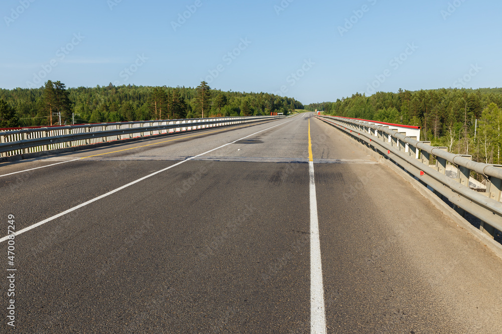 Fototapeta premium Asphalt road. Automobile bridge over the railway in Siberia.