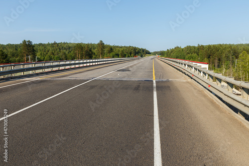 Asphalt road. Automobile bridge over the railway in Siberia.