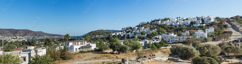 Landscape with a view of a small settlement with beautiful white houses on the mountainside.