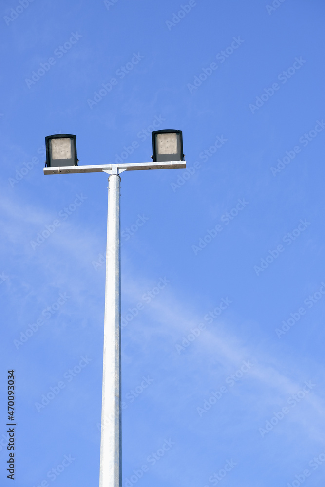 Modern park LED luminaire on a tall metal mast. Modern park LED luminaire on a tall metal mast.