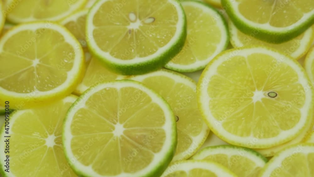 Healthy Vegetarian Food with Vitamin C to Boost Immunity During Seasonal Viral Diseases. Juicy Sliced Lemons Limes Slices, Close-up, Rotation, Isolated, Citrus Fruit. Healthy Vegetarian Food with Vitamin C to Boost Immunity During Seasonal Viral Diseases. Juicy Sliced Lemons Limes Slices, Close-up, Rotation, Isolated, Citrus Fruit.