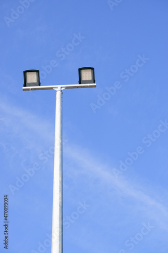 Modern park LED luminaire on a tall metal mast.