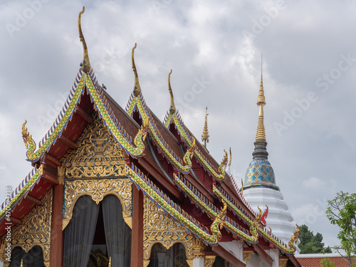 Fototapeta Scenic landscape view of ancient Wat Pan Ping vihara and white stupa after recon