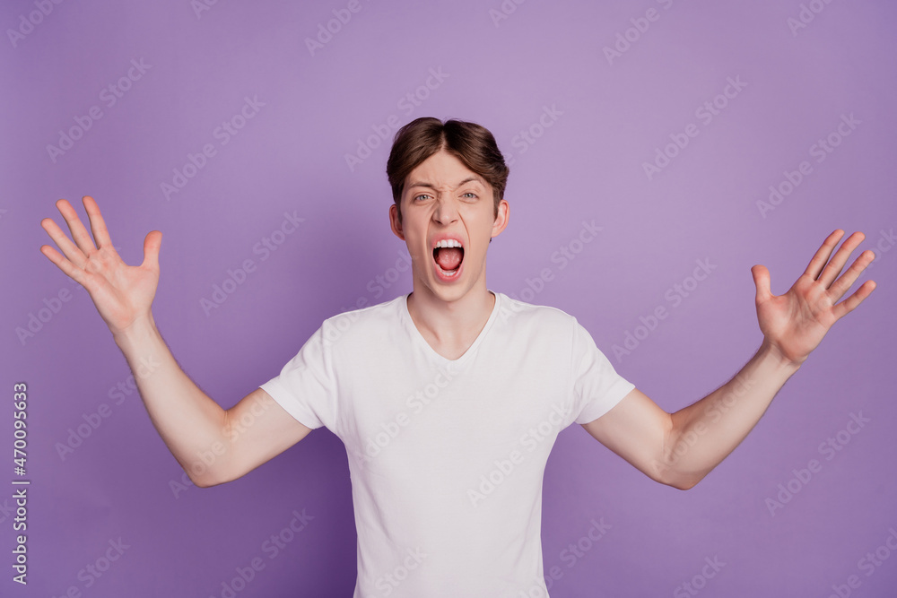Photo of young man unhappy bad negative shout angry mad conflict isolated over violet color background Photo of young man unhappy bad negative shout angry mad conflict isolated over violet color background