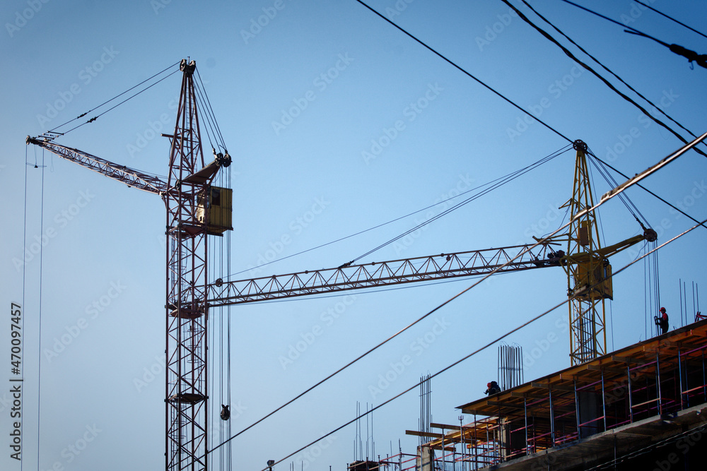 Tower cranes are working on the construction of a multi-storey building Tower cranes are working on the construction of a multi-storey building