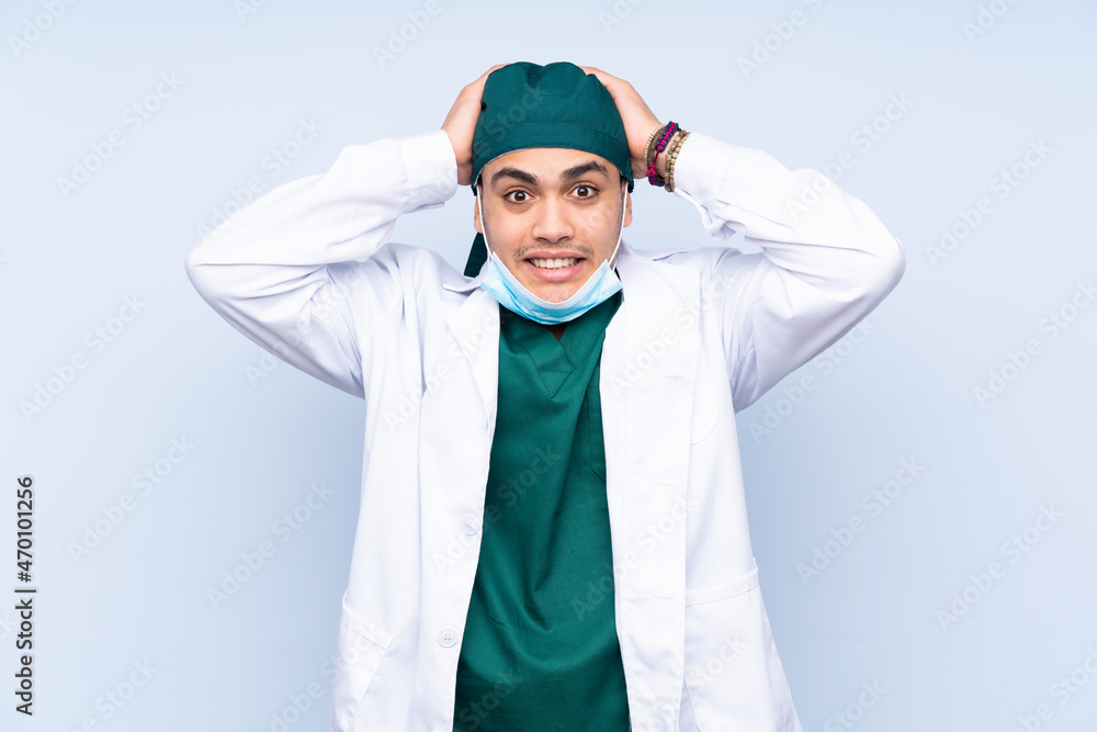 Surgeon man with uniform isolated on blue background with surprise facial expression Surgeon man with uniform isolated on blue background with surprise facial expression