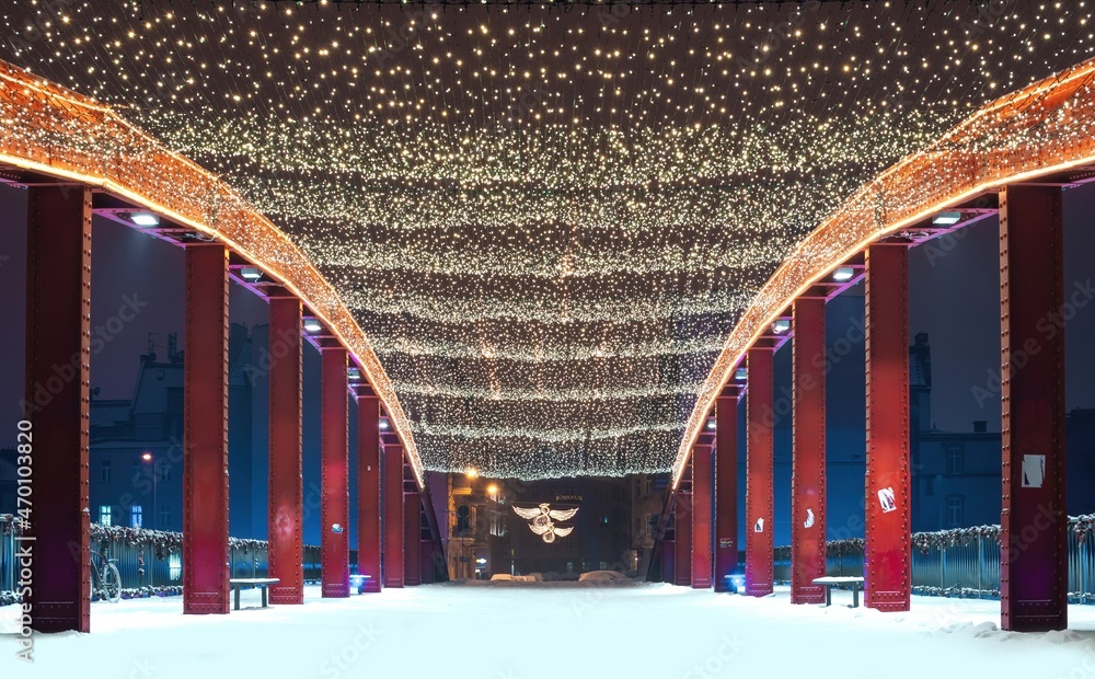 Bridge at the Ostrow Tumski decorated with illuminated Christmas ornaments in Poznan, Poland