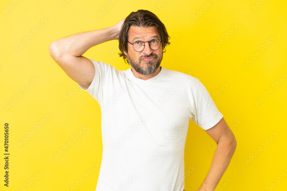 Senior dutch man isolated on yellow background with an expression of frustration and not understanding Senior dutch man isolated on yellow background with an expression of frustration and not understanding