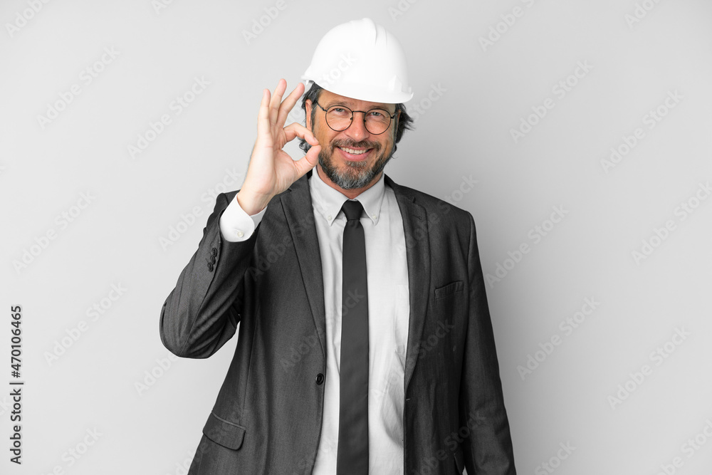 Young architect man with helmet over isolated background showing ok sign with fingers Young architect man with helmet over isolated background showing ok sign with fingers