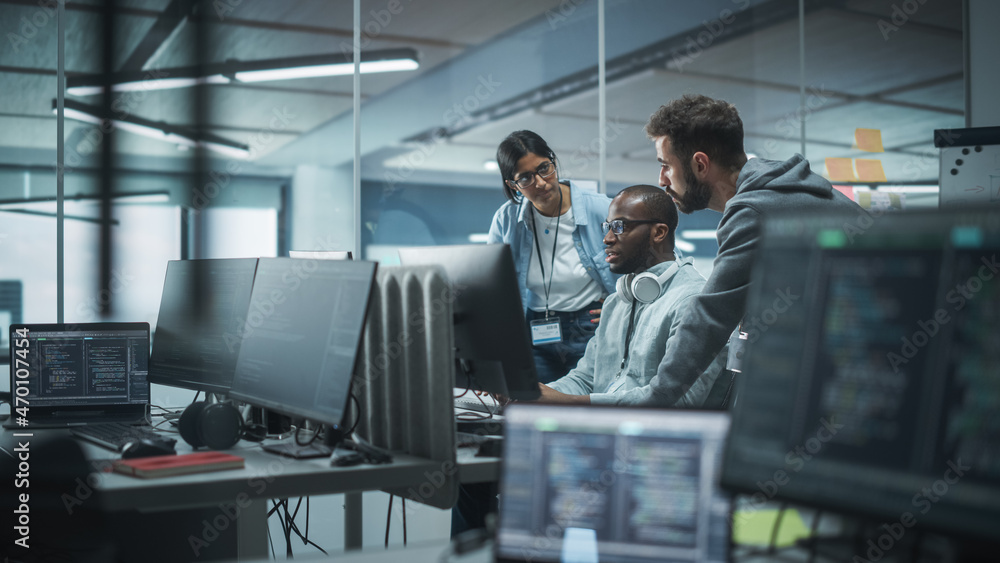 Diverse Multi-Ethnic Team Working in Modern Office: Group of IT Programmers Gather Around Desktop Computer, Talking, Finding Solution. Specialists Create Software. Engineers Develop App, Program Diverse Multi-Ethnic Team Working in Modern Office: Group of IT Programmers Gather Around Desktop Computer, Talking, Finding Solution. Specialists Create Software. Engineers Develop App, Program