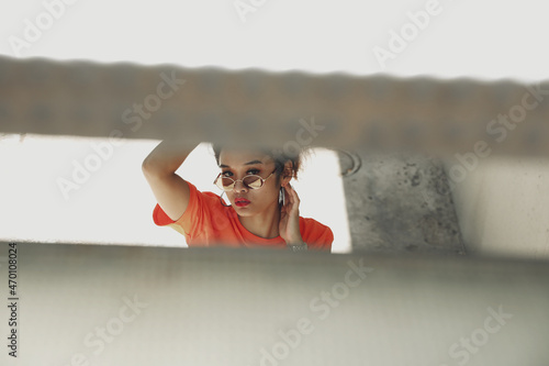 Attractive Asian woman posing on sunny summer or spring day outside in city. photo