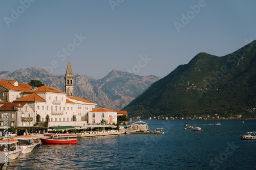 Pier with boats in the background of Perast buildings. Montenegro