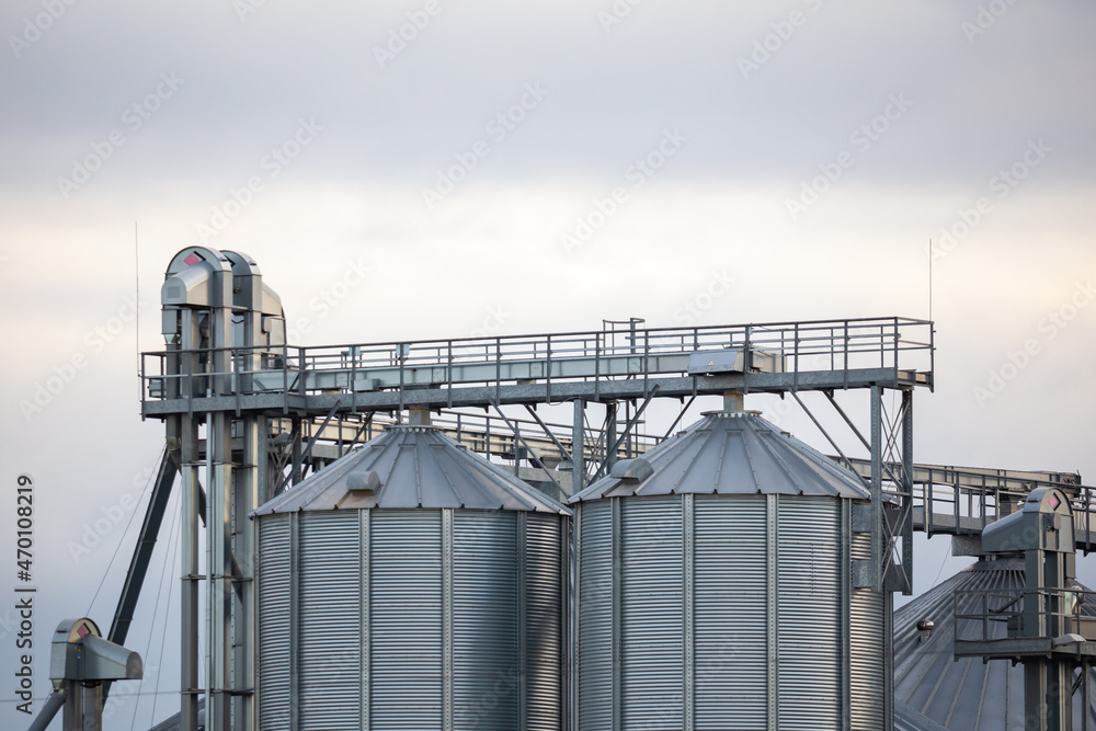 Close-up on steel grain silo in the fields. Photo taken in natural lighting, soft light