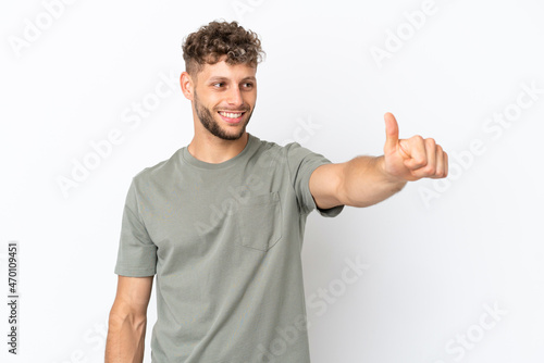 Young caucasian handsome man isolated on white background giving a thumbs up gesture