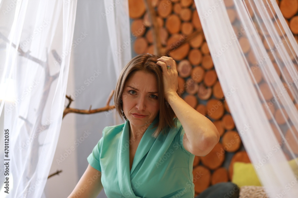 Fototapeta premium Lady sitting on a bed in the room