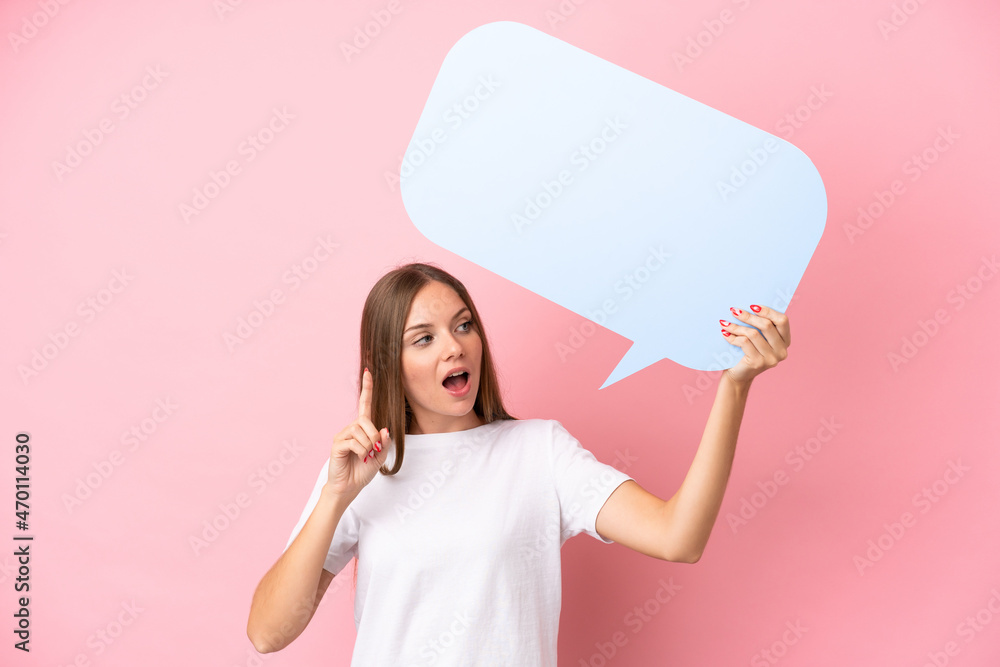 Young Lithuanian woman isolated on pink background holding an empty speech bubble and thinking Young Lithuanian woman isolated on pink background holding an empty speech bubble and thinking