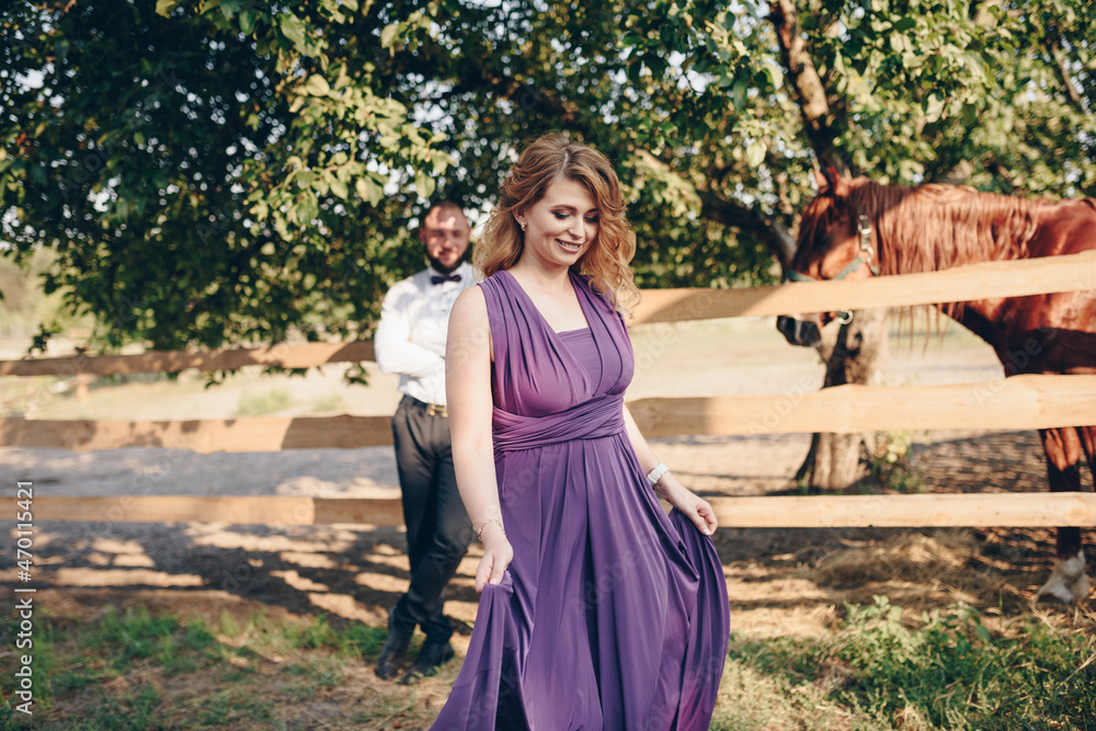 A loving couple on a date. Horseback riding. Purple dress. A loving couple on a date. Horseback riding. Purple dress.