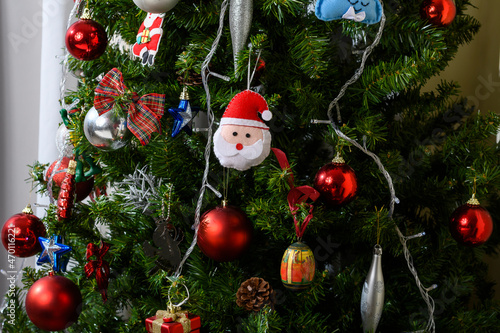 Christmas tree with decoration, balls, lights, Santa Claus ornaments, symbolizing Christmas