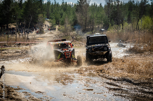 ATV and UTV riders driving in water mud road. Extreme ride. 4x4. Dirty wheels.