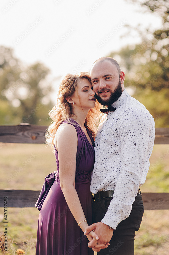 Couple on a date. Purple dress. Bride and groom. Walk in the field. Love story. Couple on a date. Purple dress. Bride and groom. Walk in the field. Love story.