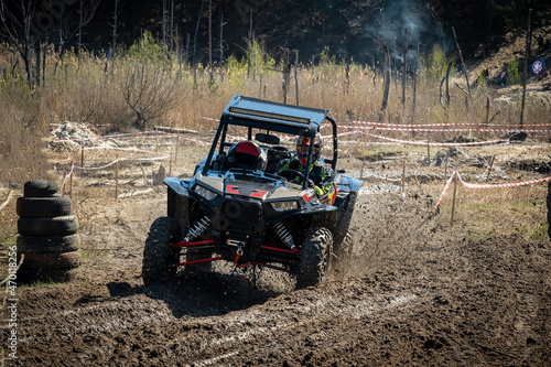 ATV and UTV offroad vehicle racing in hard track with mud splash. Amateur competitions. 4x4. photo