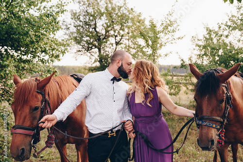 The groom in a white shirt and a purple bow tie. Horse riding.