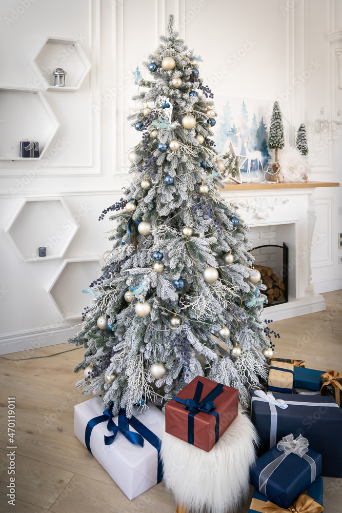Luxury interior of living room with decorated Christmas tree and gifts on the wooden floor. Luxury interior of living room with decorated Christmas tree and gifts on the wooden floor.