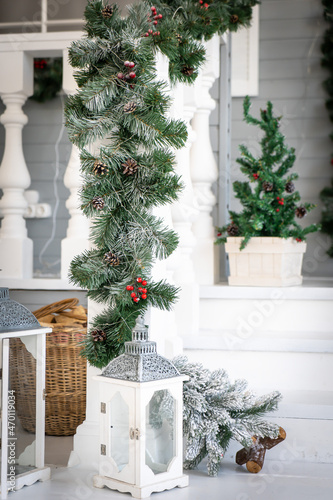 Christmas morning. porch a small house with a decorated door with a Christmas wreath. Winter fairy tale. © Iryna