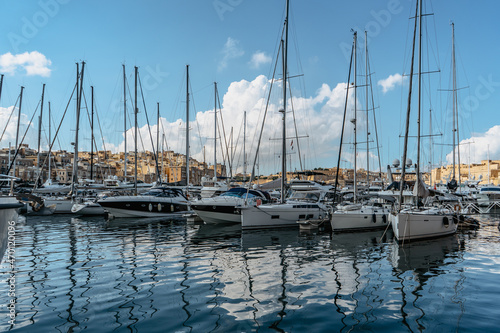 Luxury boats and yachts in the harbor. Sunny summer day. Holiday high-class lifestyle travel concept. Boat trip in the Mediterranean.View of expensive sailing yachts at the pier.Marine dock. © Eva