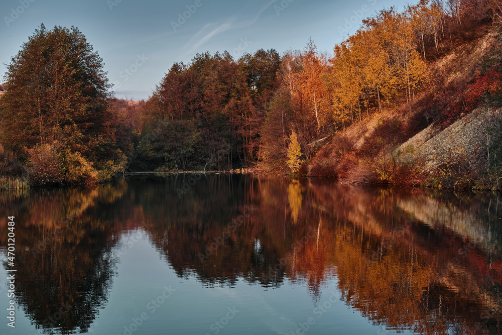 autumn trees reflected in water autumn trees reflected in water