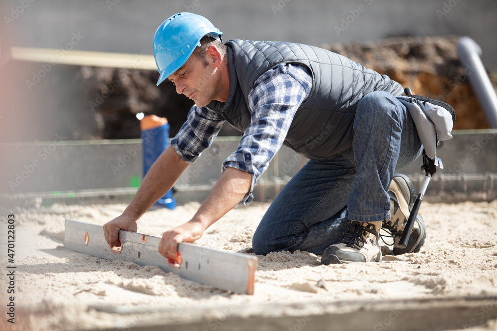 builder leveling floor at site