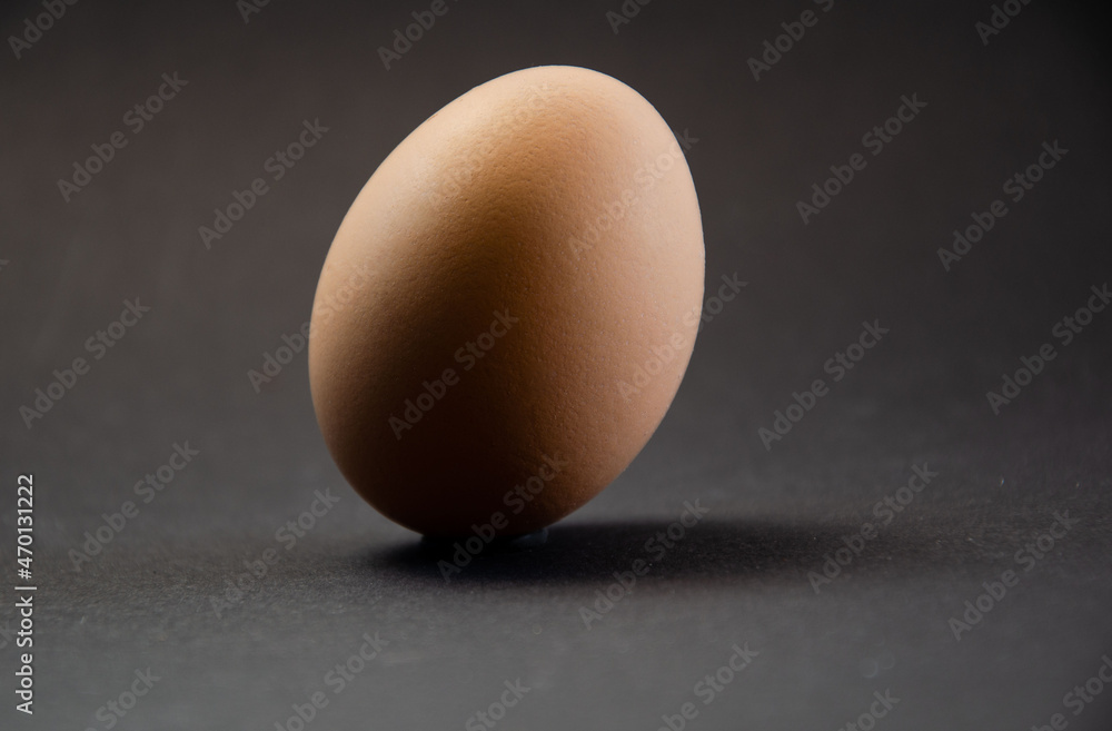 Egg on a black background. minimalism of still life. composition for cover Egg on a black background. minimalism of still life. composition for cover