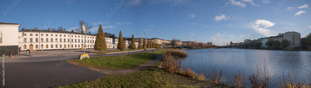 The channel Klarabergskanalen at the castle Karlbergs Slott and the down town city at the skyline a sunny autumn day in Stockholm
