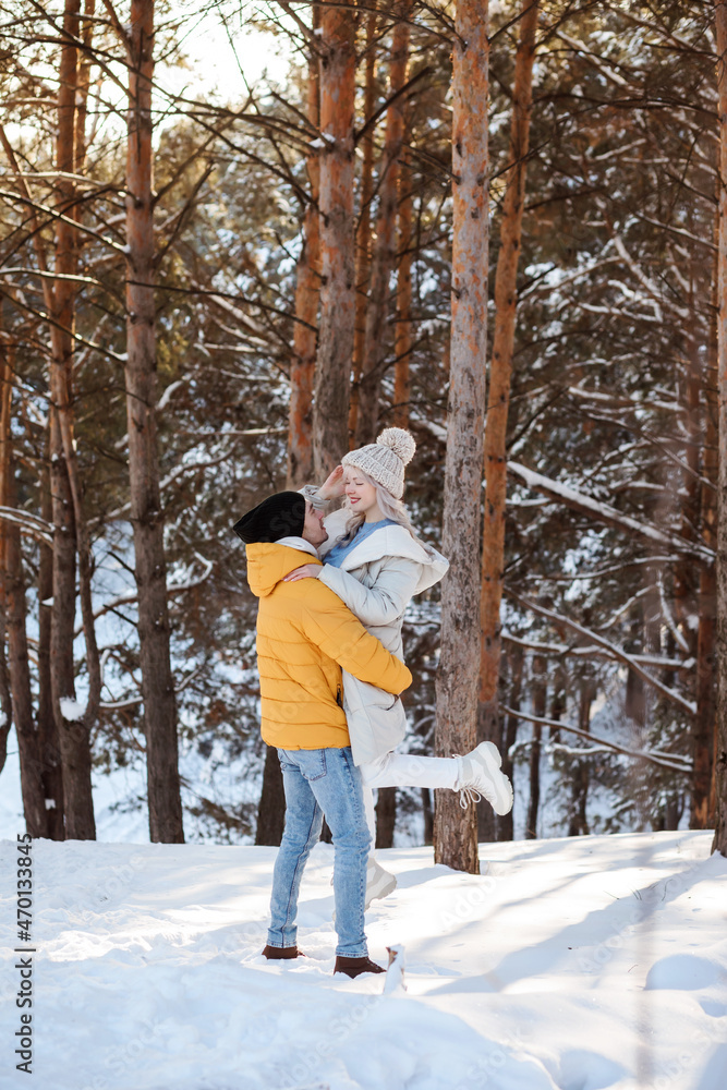 Cute couple is spending time outdoors in winter in the countryside, Christmas holidays. Cute couple is spending time outdoors in winter in the countryside, Christmas holidays.