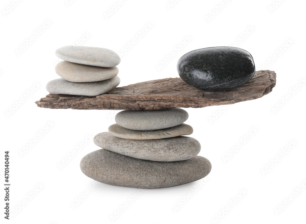 Fotografie Stack of stones with tree branch on white background