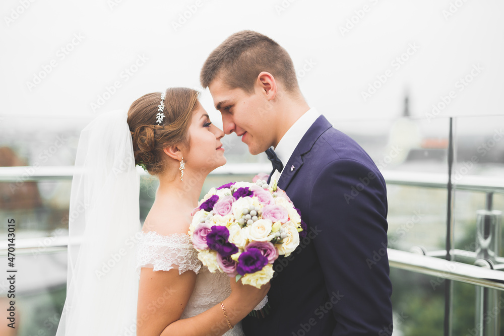Perfect couple bride, groom posing and kissing in their wedding day Perfect couple bride, groom posing and kissing in their wedding day