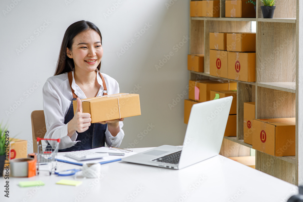 Portrait of Starting small businesses SME owners female entrepreneurs working on receipt box and check online orders to prepare to pack the boxes, sell to customers, sme business ideas online. Portrait of Starting small businesses SME owners female entrepreneurs working on receipt box and check online orders to prepare to pack the boxes, sell to customers, sme business ideas online.