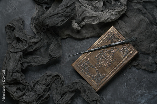 Subjects of the school of magic. Book of spells on dark grey background.