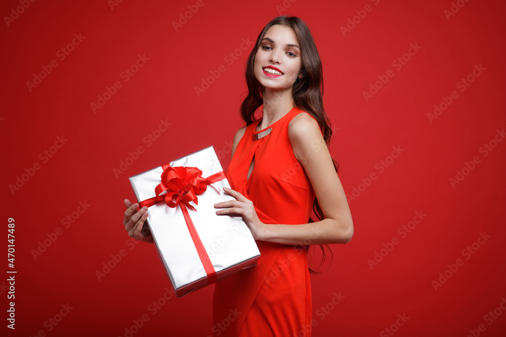 Beautiful young woman, evening makeup stylish dress , brunette, gifts boxes red silk bows holiday party birthday, New Year, Christmas, Valentine's Day. Fashion photo. Studio Shot. Total red color. Beautiful young woman, evening makeup stylish dress , brunette, gifts boxes red silk bows holiday party birthday, New Year, Christmas, Valentine's Day. Fashion photo. Studio Shot. Total red color.