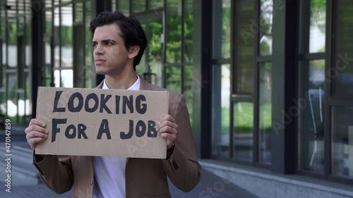 Wallpaper Mural dismissed man holding carton with looking for a job lettering outside Torontodigital.ca