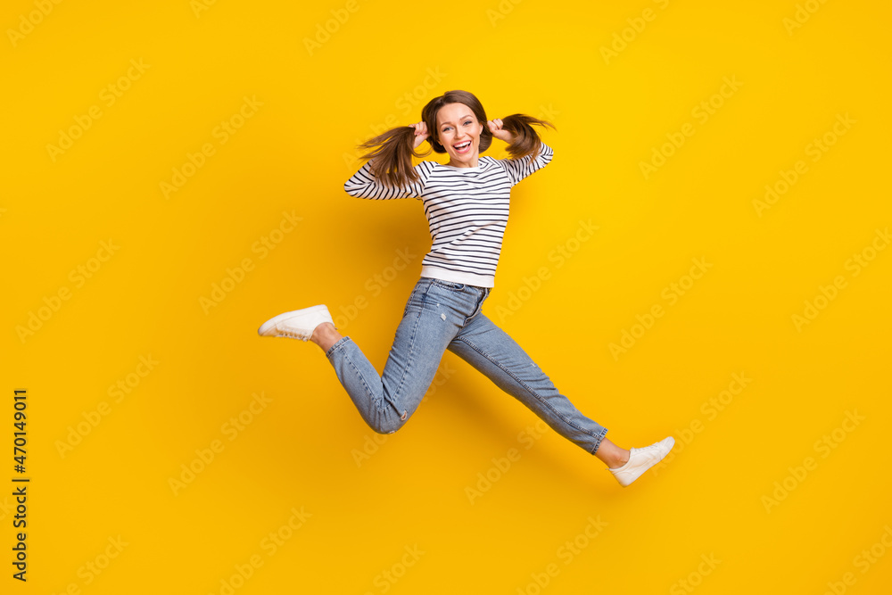 Full body photo of celebrate brunette young lady run wear jumper jeans footwear isolated on yellow color background