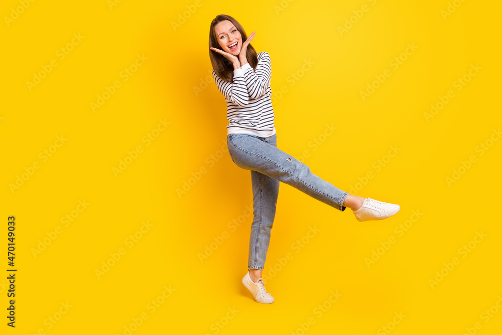 Full size photo of cool brunette millennial lady dance wear jumper jeans footwear isolated on yellow color background Full size photo of cool brunette millennial lady dance wear jumper jeans footwear isolated on yellow color background
