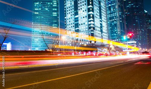 Canvas Print moving car with blur light through modern city at night.
