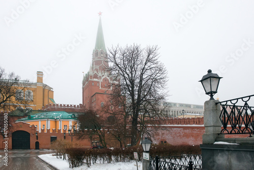 Moscow, Russia. Alexander Garden (Aleksandrovsky Sad) and Troitskaya Tower of the Moscow Kremlin аt winter in fog. Misty winter morning in Moscow.