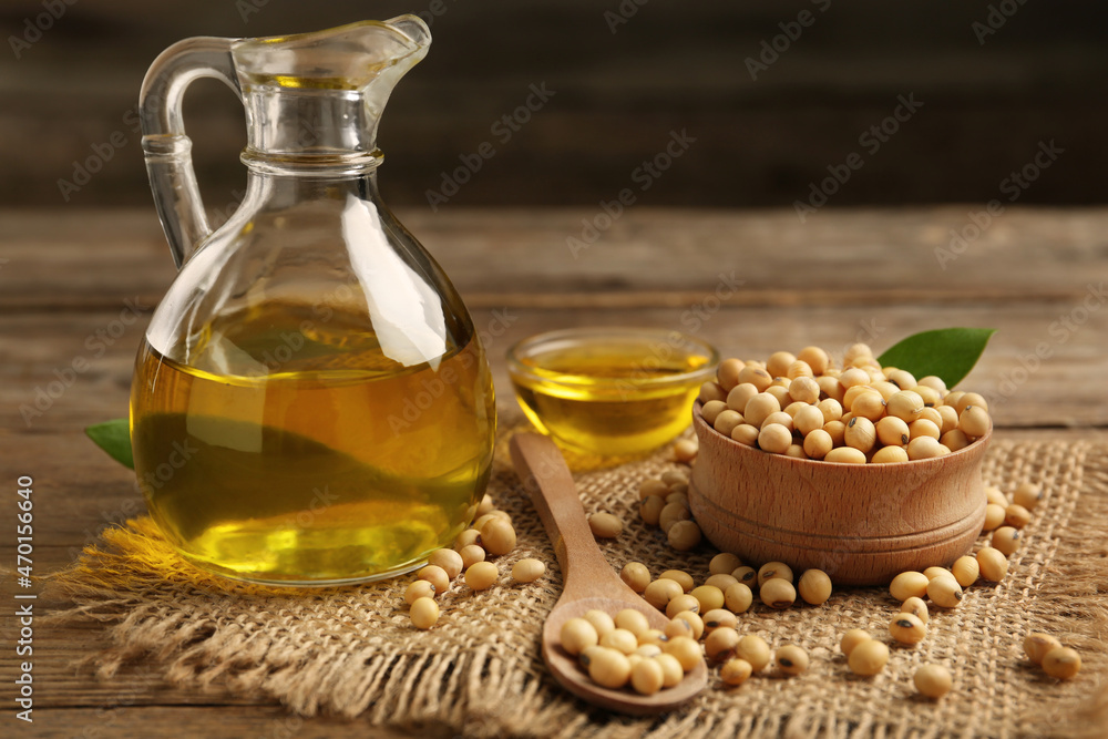 Composition with soybean oil on wooden table, closeup Composition with soybean oil on wooden table, closeup