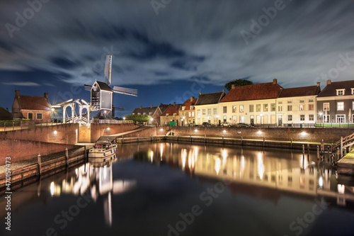 Historical harbor with windmill, drawbridge and mansions at night, Heusden, The Netherlands