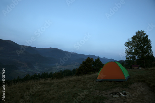 Camping tent on mountain slope in morning