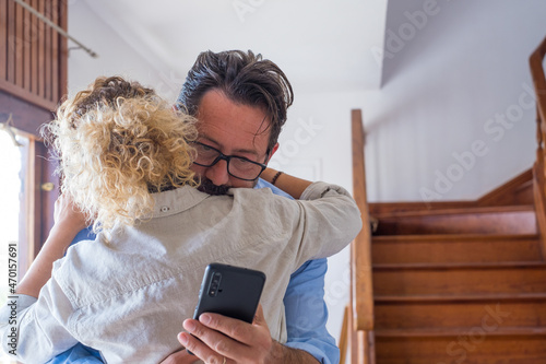 Obraz na plátně Cheater man sending text messaging to lover using mobile phone while embracing his wife at home